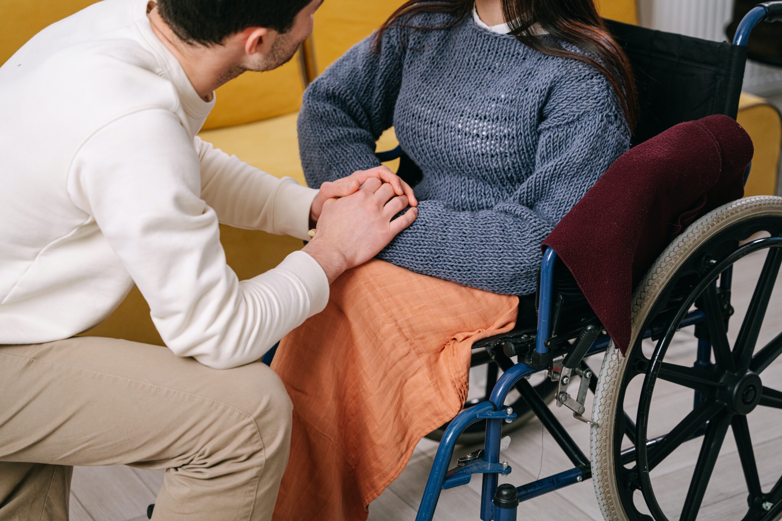 caregiver helping patient in wheelchair