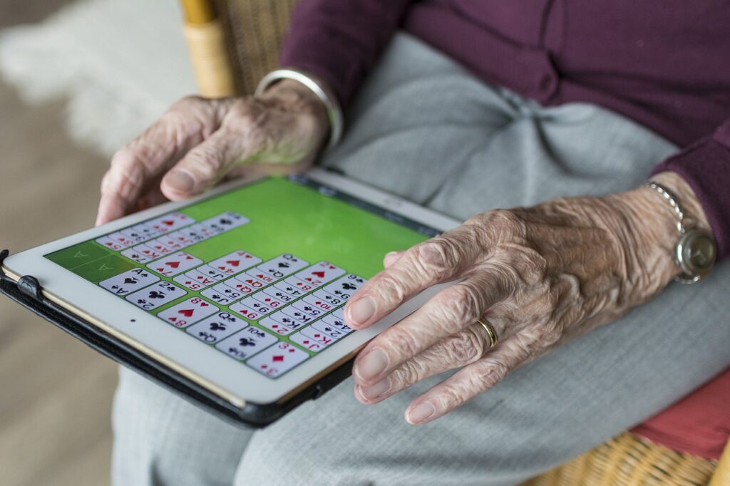 Senior Hand Playing tablet3