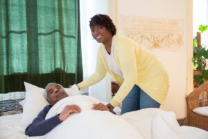 caregiver helping bed